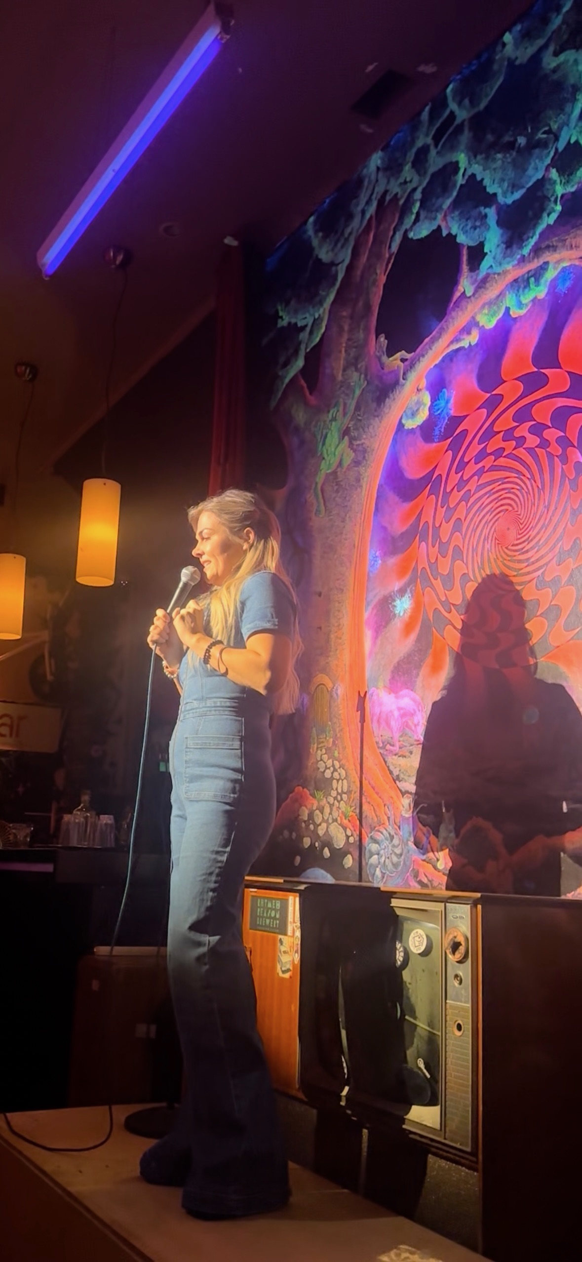 Hannah on stage at a comedy club