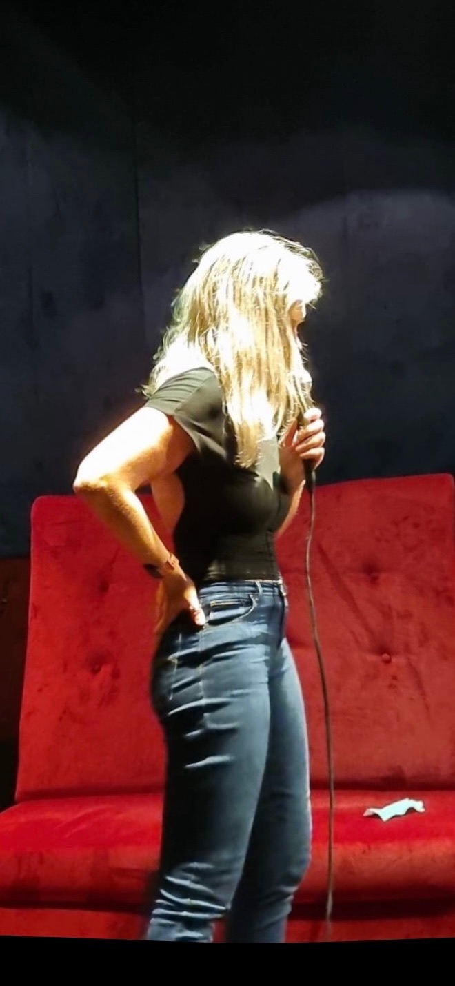 Hannah on stage with a microphone