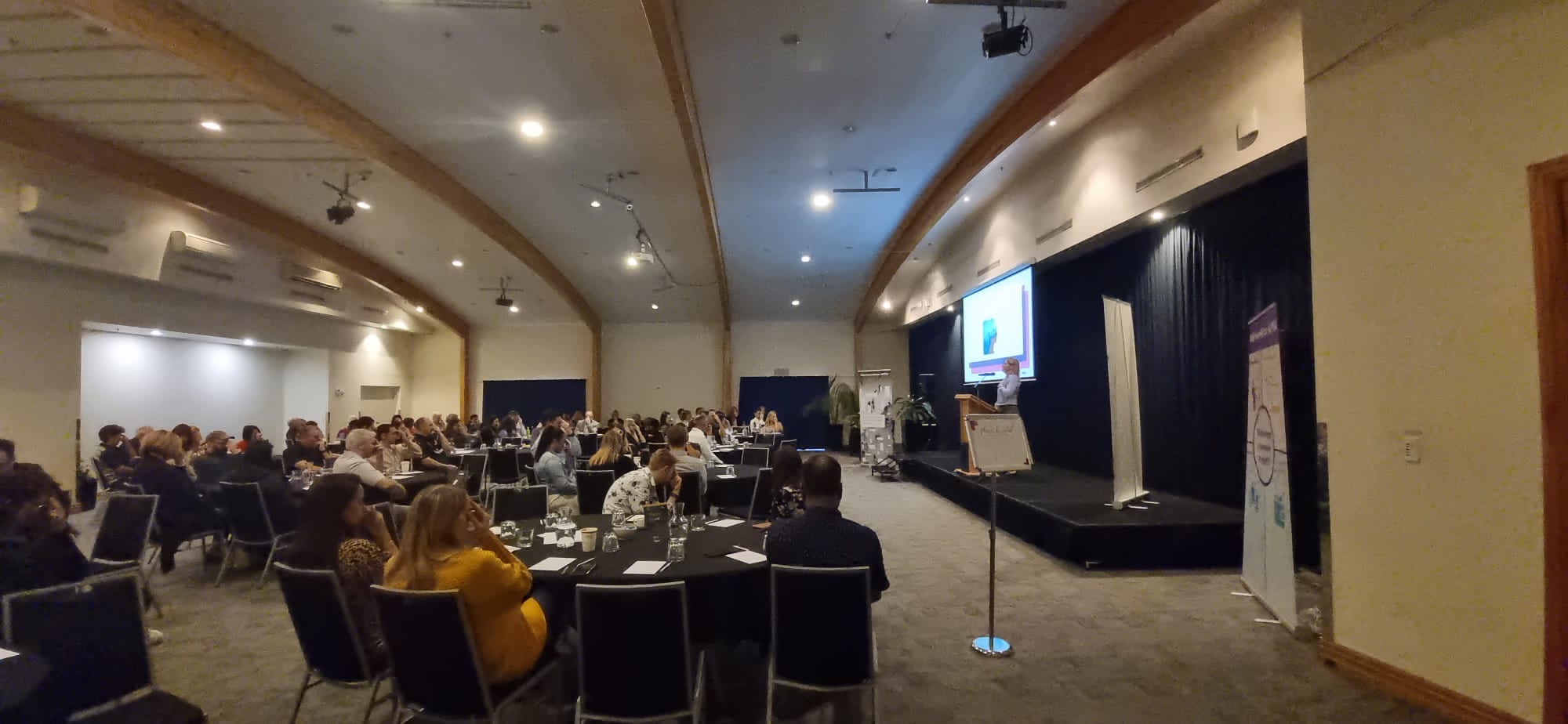 Hannah speaking to a full room