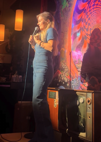 Hannah doing stand-up at a small club